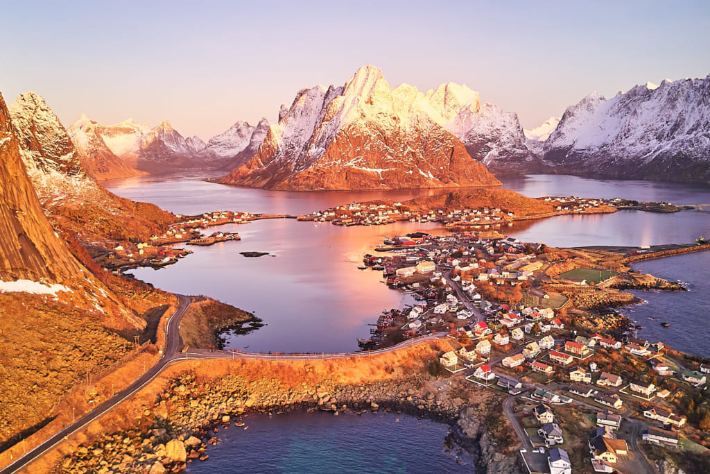 ©Johny Goerend "Aerial view of Reine, unfortunately without snow. Still, the light just after sunrise made the whole landscape seem unrealistically beautiful."